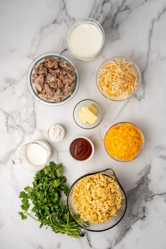 an overhead image showing the measured ingredients needed to make a pulled pork mac and cheese skillet