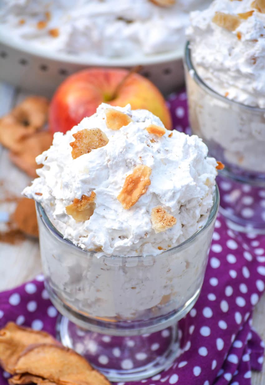 Apple Pie Fluff Salad apple pie fluff salad in two glass jars topped with pieces of crumbled pie crust