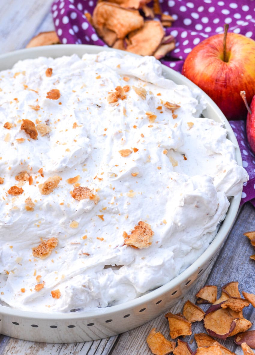 apple pie fluff salad in a wide shallow bowl surrounded by apple chips