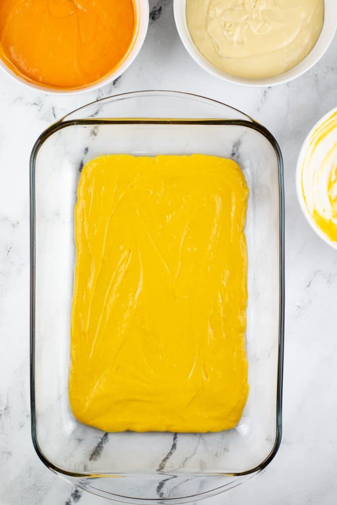 yellow cake batter in a clear glass baking dish