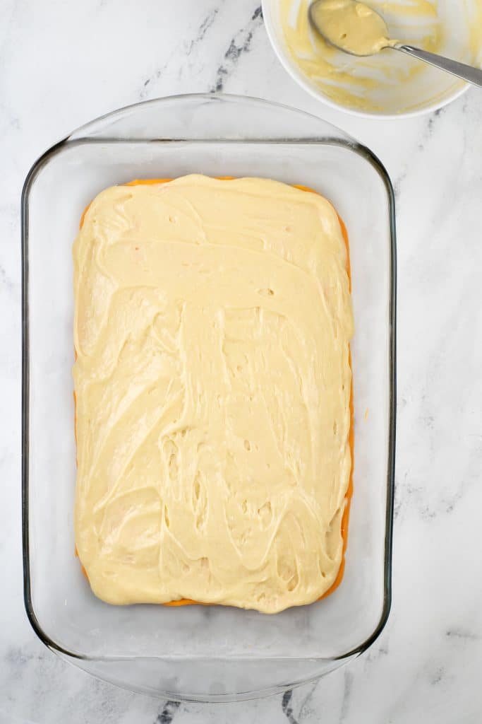 white cake batter in a clear glass baking dish
