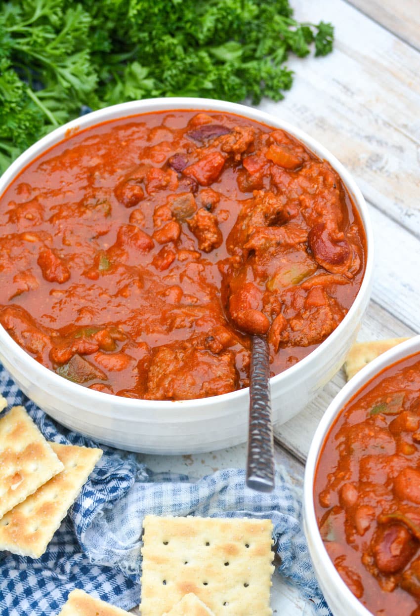a silver spoon stuck in a bowl of wendy's hamburger chili