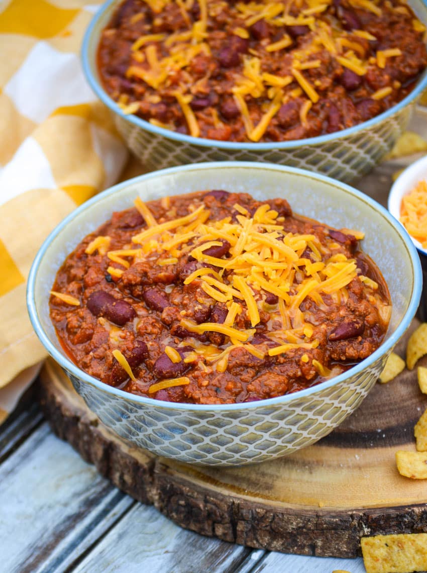 Instant pot chili in two bowls on a wooden cutting board