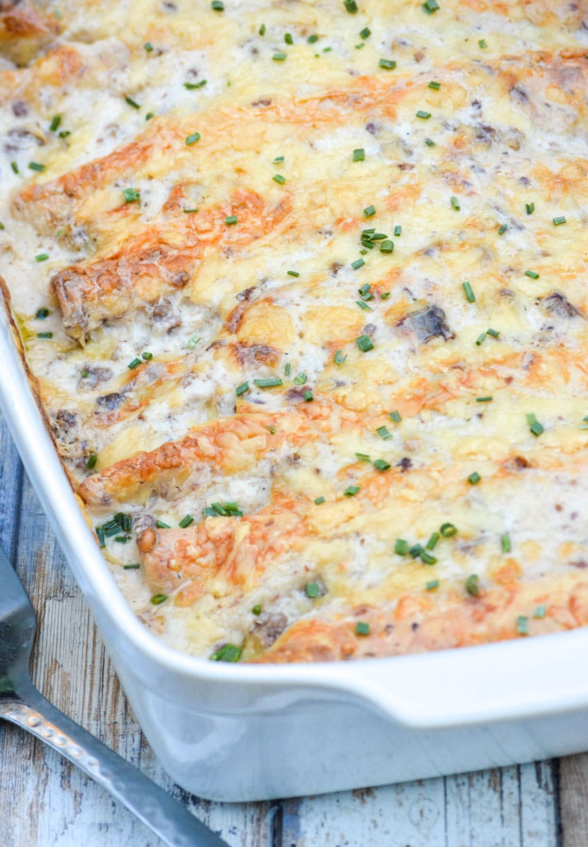 sausage gravy breakfast enchiladas in a white baking dish