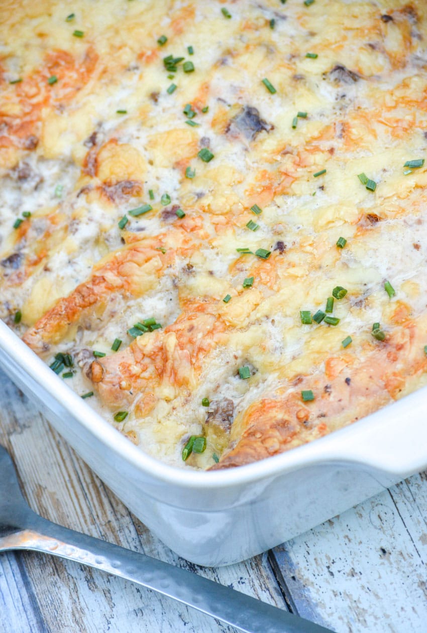 sausage gravy breakfast enchiladas in a white baking dish