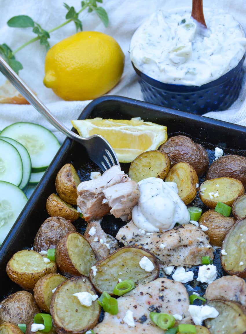 a fork digging into lemon feta sheet pan chicken