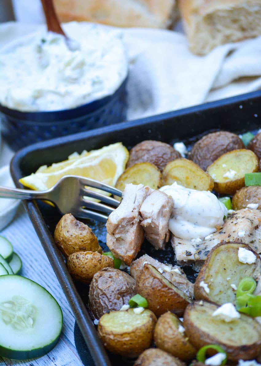 a fork digging into lemon feta sheet pan chicken