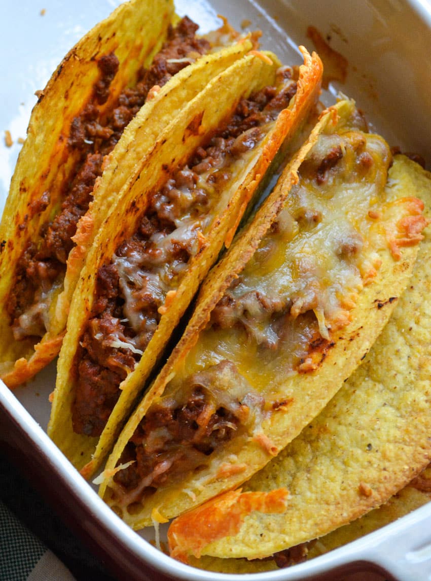 cheesy baked sloppy joe tacos in a red casserole dish