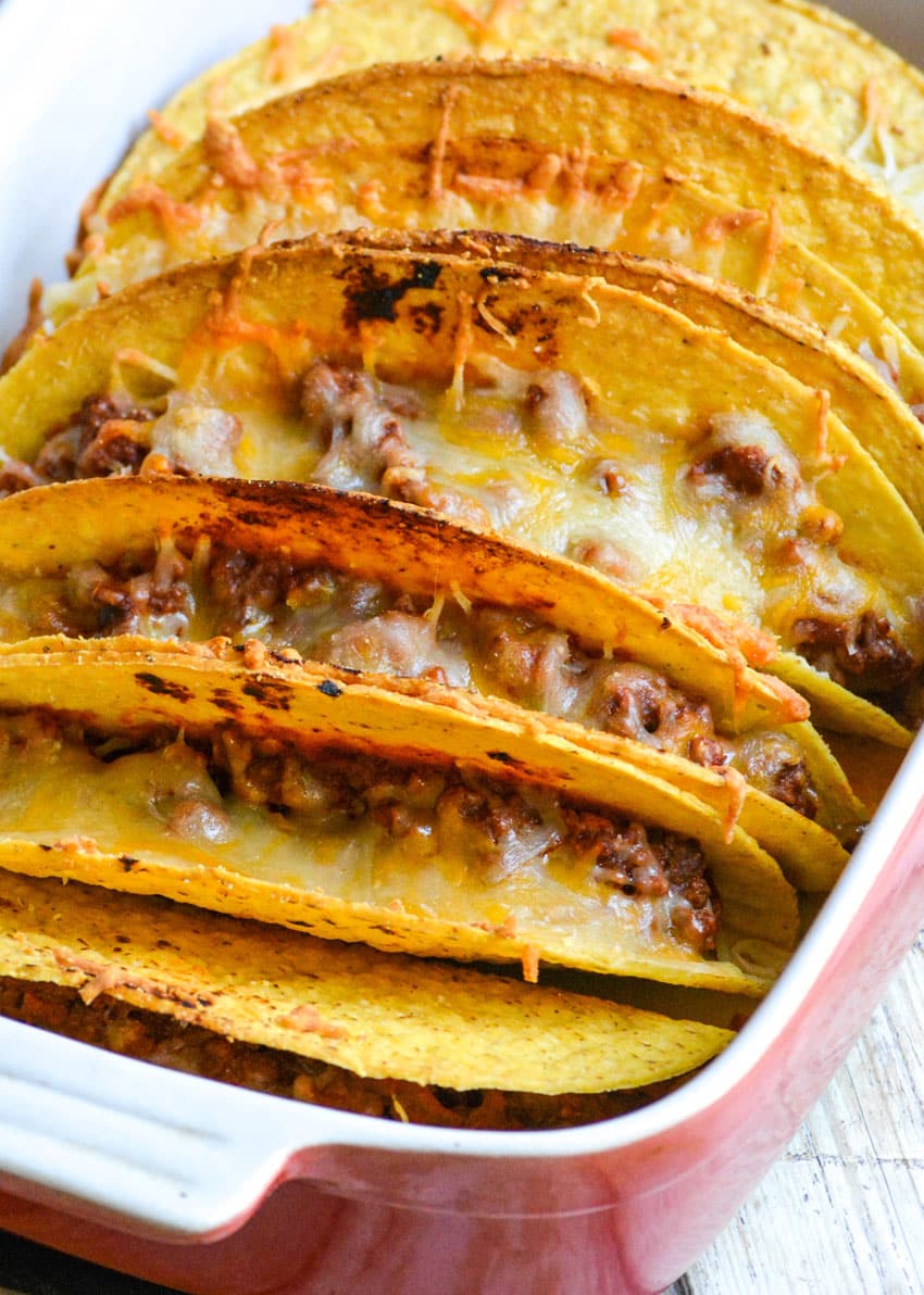 cheesy baked sloppy joe tacos in a red casserole dish