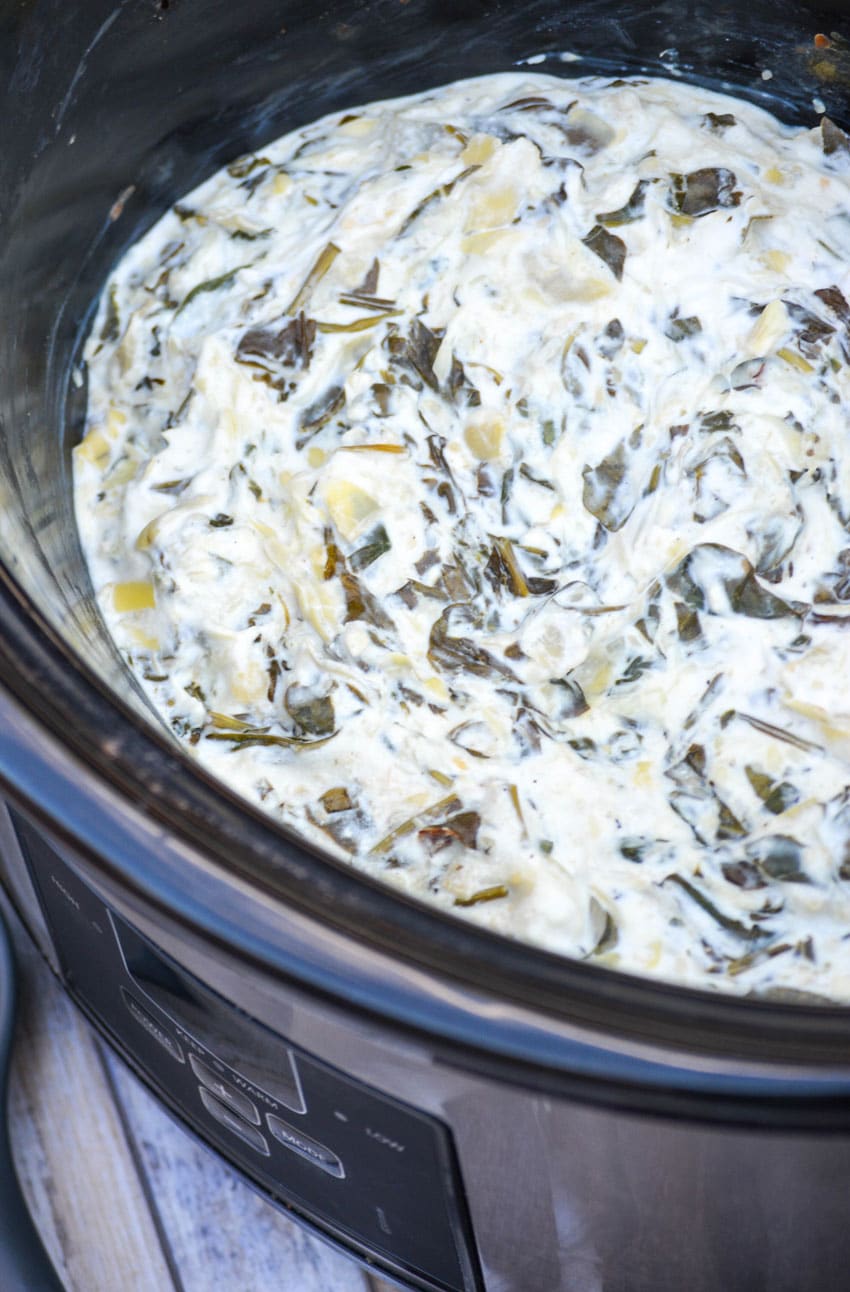 Crockpot Spinach & Artichoke Dip slow cooker spinach and artichoke dip in the black bowl of a crockpot