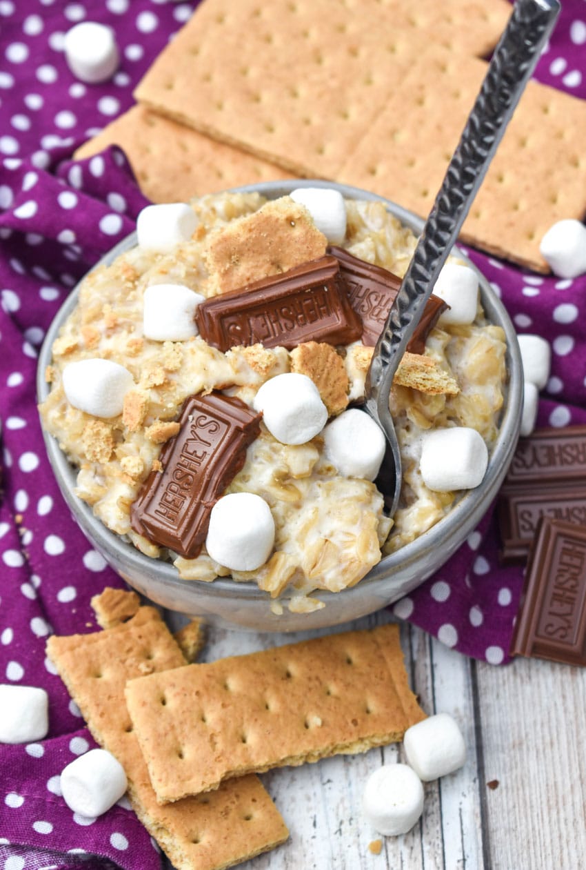 a silver spoon stuck in a small bowl of s'mores oatmeal
