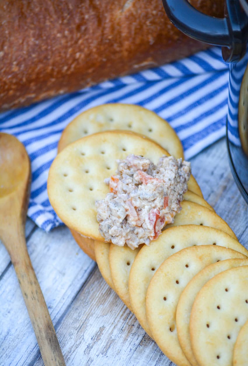 creamy rotel dip with sausage on a large water cracker