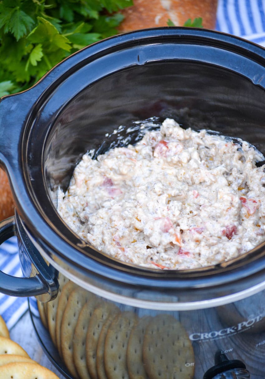 3 ingredient sausage dip in the black bowl of a crockpot