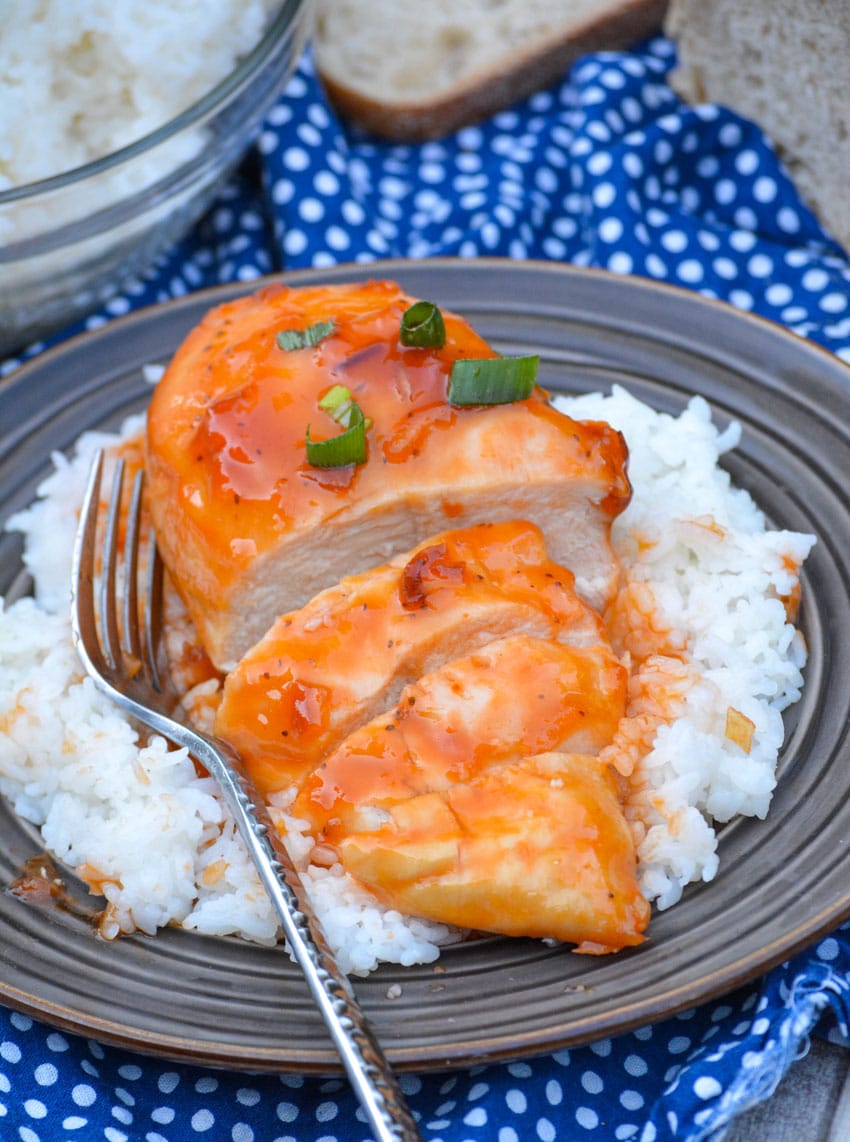 baked russian chicken on a bed of steamed white rice on a brown plate