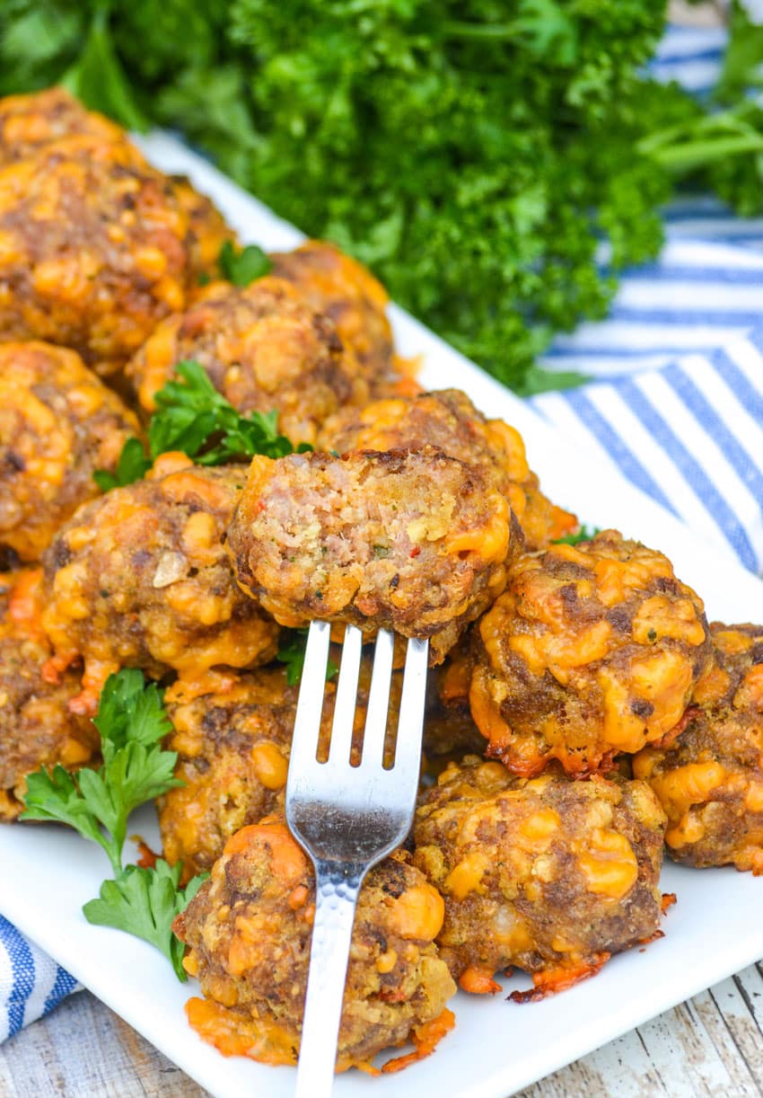a fork stuck in a sausage ball with cheese