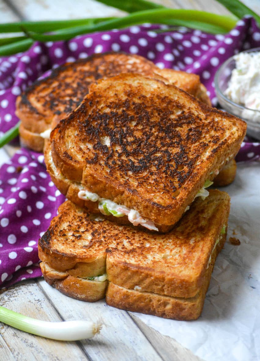 a stack of three crab rangoon grilled cheese sandwiches