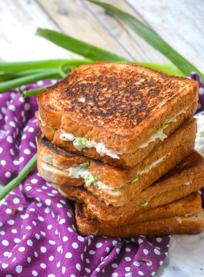 a stack of three crab rangoon grilled cheese sandwiches
