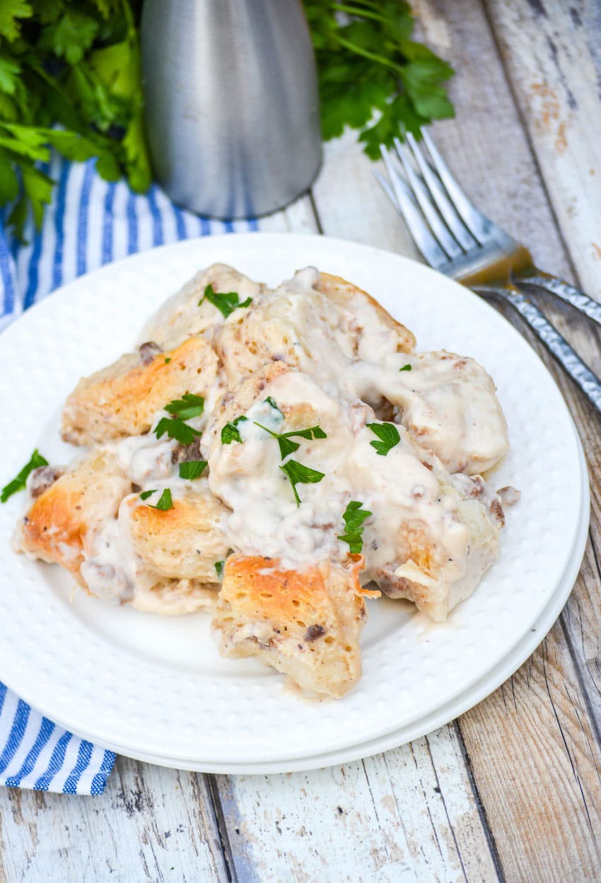 sausage gravy and biscuits casserole on a white plate