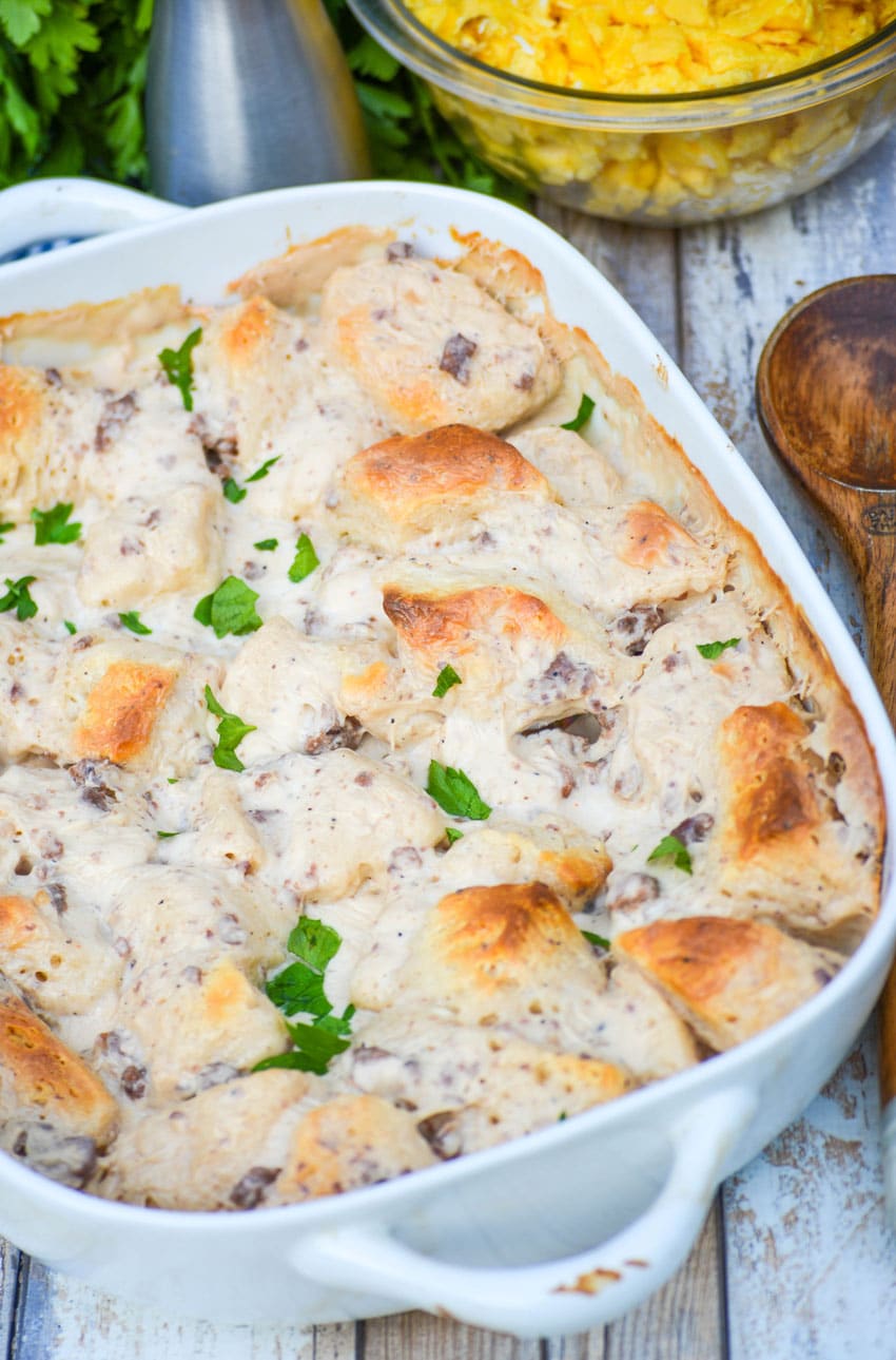 sausage gravy & biscuits casserole in a white baking dish