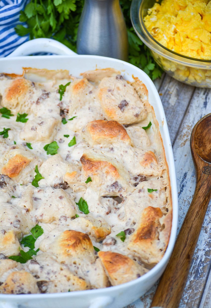 sausage gravy & biscuits casserole in a white baking dish