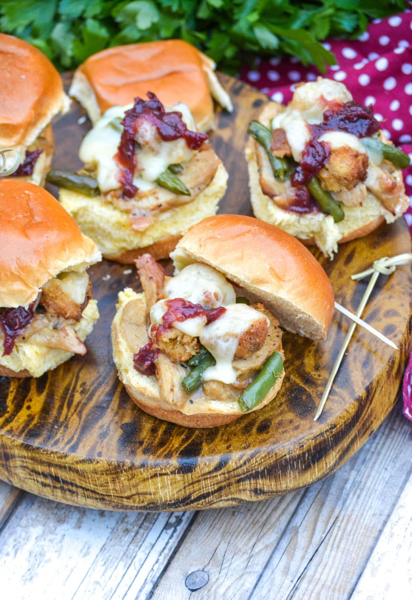 thanksgiving sliders on a small wooden cutting board with tooth picks on the side