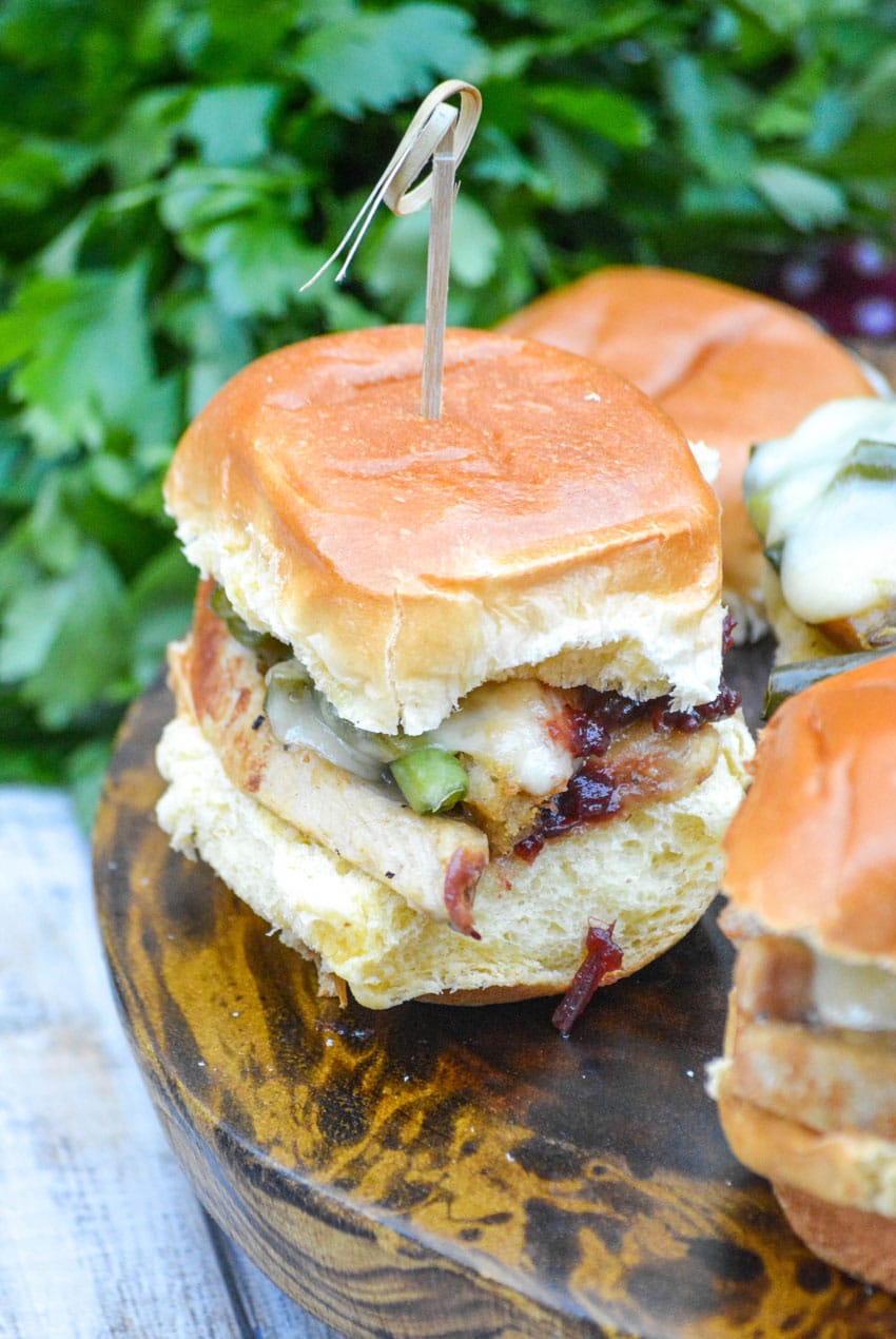 thanksgiving sliders on a small wooden cutting board with tooth picks on the side