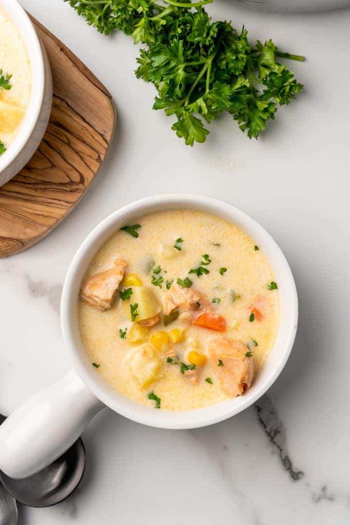 a white bowl filled with canned salmon chowder