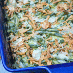 basil pesto green bean casserole in a blue casserole dish