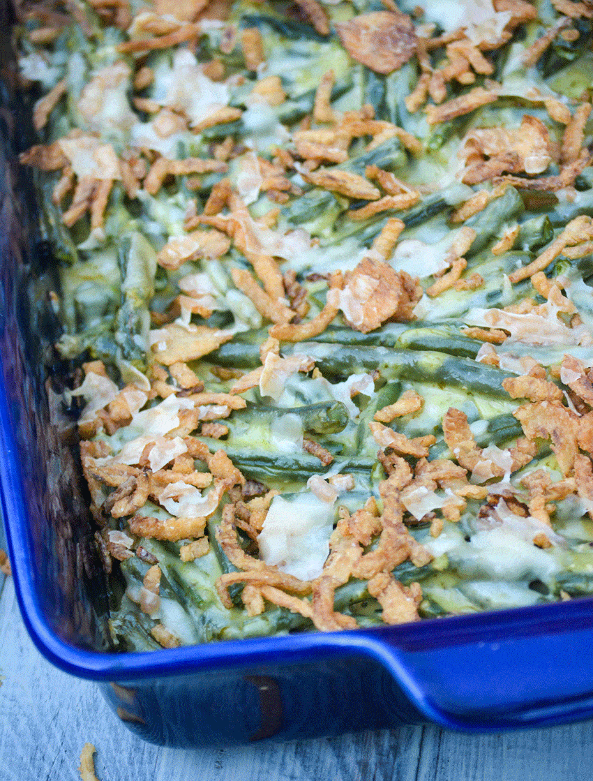 basil pesto green bean casserole in a blue casserole dish