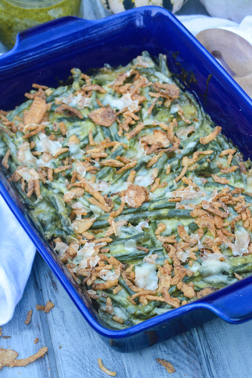 basil pesto green bean casserole in a blue casserole dish