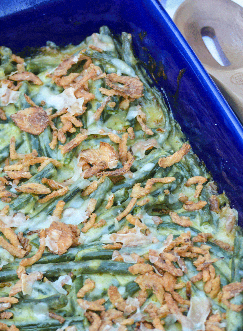 basil pesto green bean casserole in a blue casserole dish