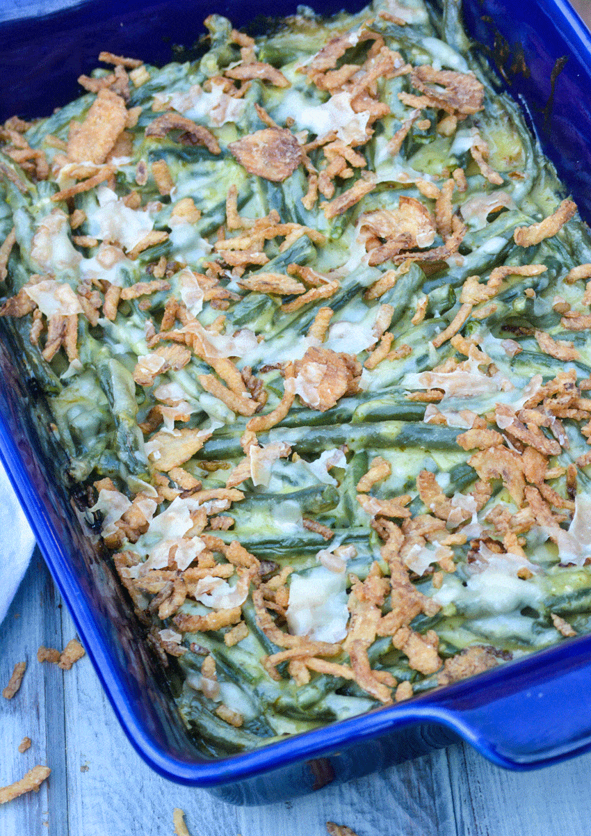basil pesto green bean casserole in a blue casserole dish