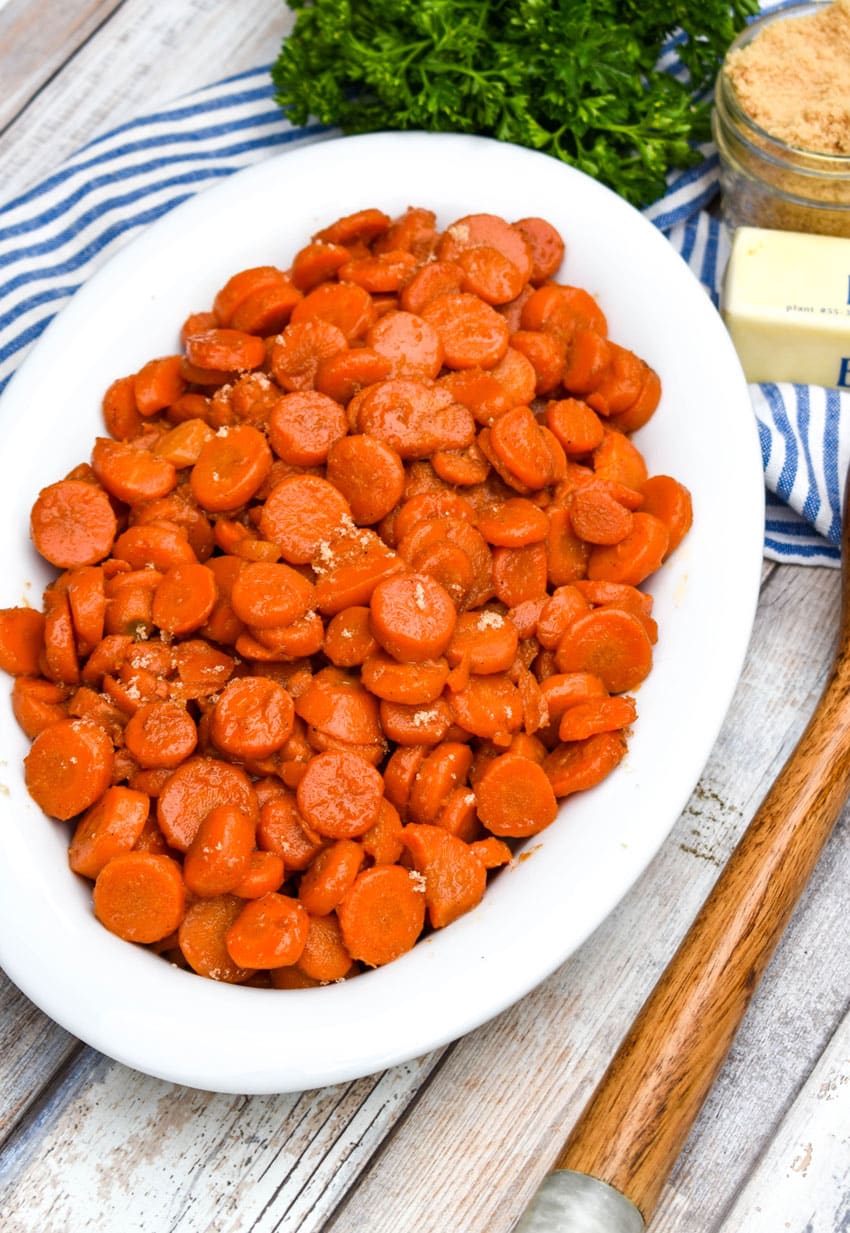 easy 5 minute brown sugar glazed canned carrots in a white serving bowl