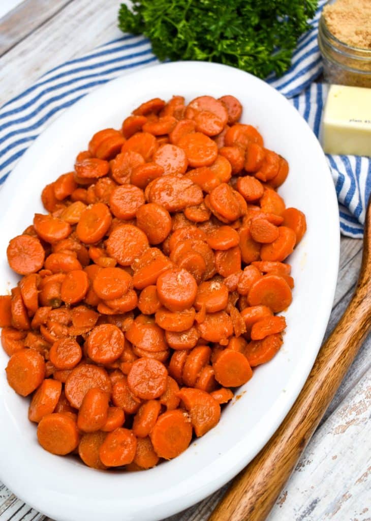 easy 5 minute brown sugar glazed canned carrots in a white serving bowl
