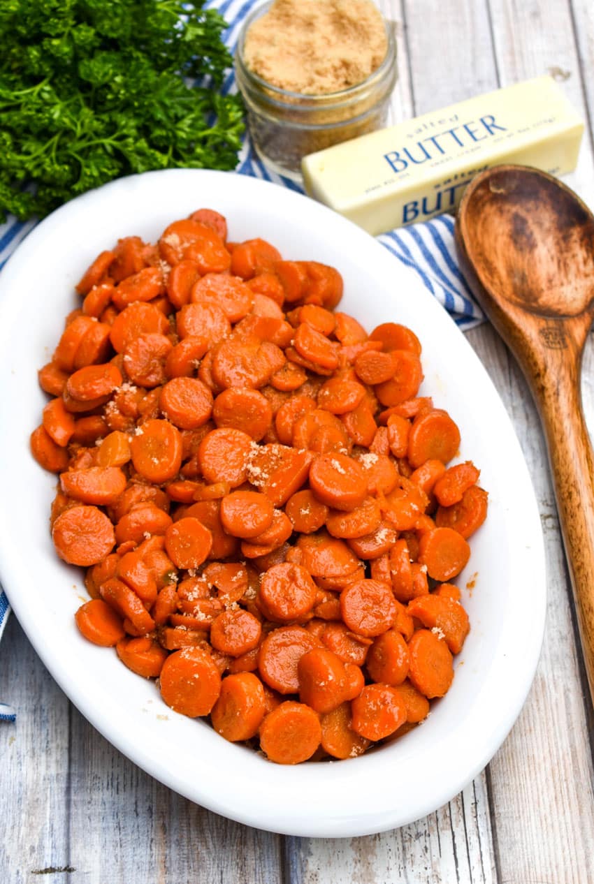 easy 5 minute brown sugar glazed canned carrots in a white serving bowl