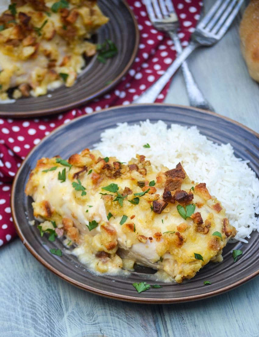 chicken in wine sauce casserole served on brown dinner plates with steamed white rice on the side