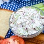 creamy leftover turkey salad in a small glass bowl on a wooden cutting board