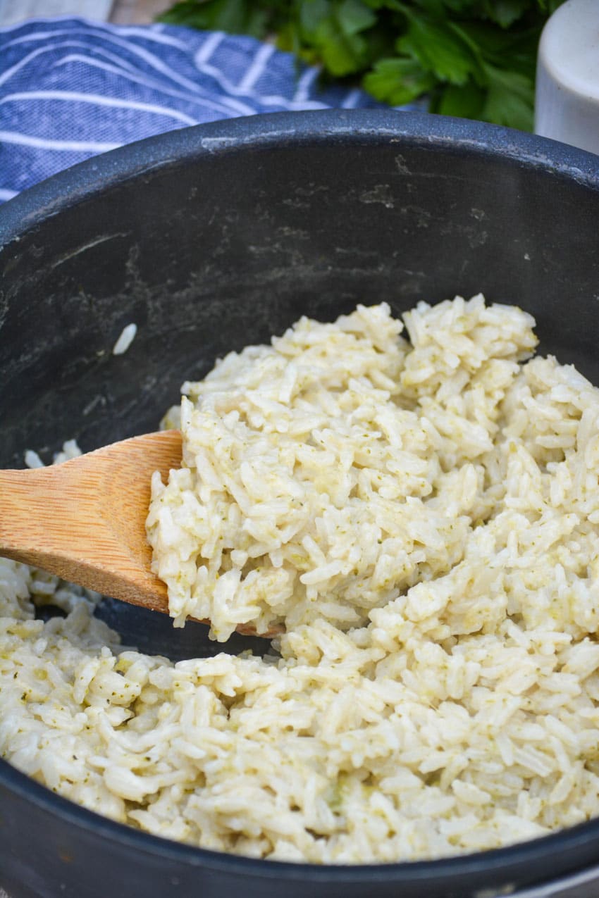 a wooden spoon in a pot of 3 ingredient savory rice
