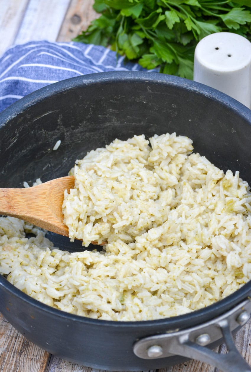 souper rice in a black pot with a wooden spoon