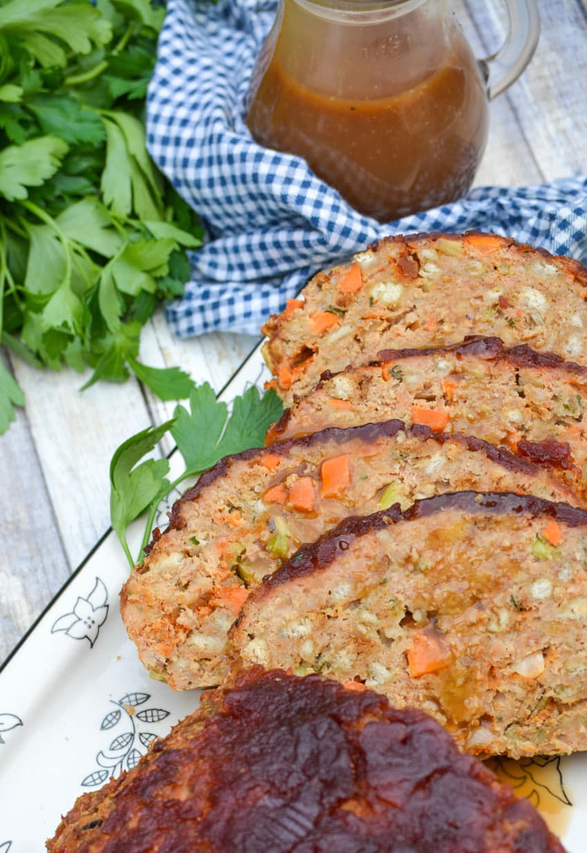 slices of Thanksgiving meatloaf arranged on a serving platter next to a meat fork