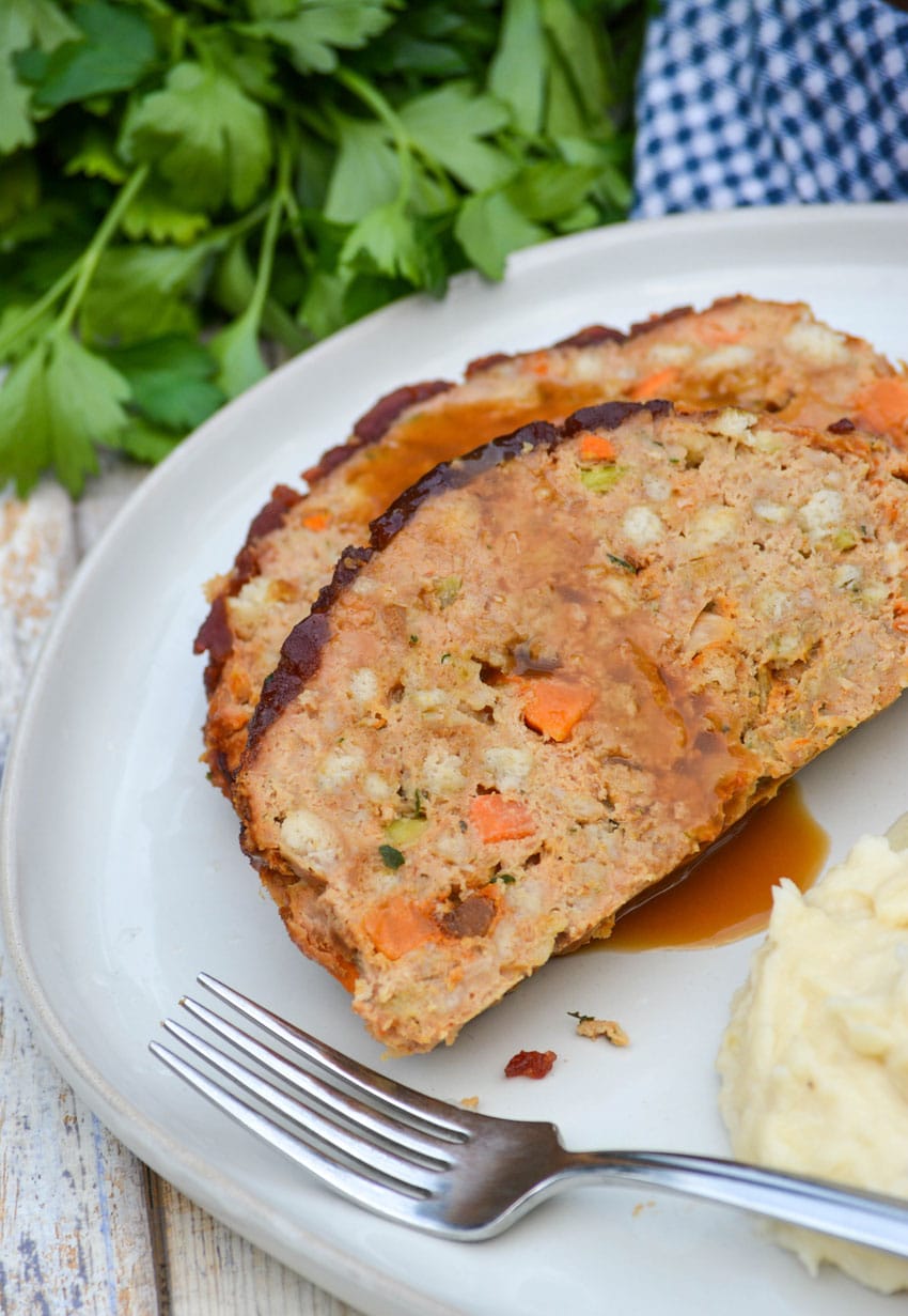 two slices of thanksgiving meatloaf on a white dinner plate