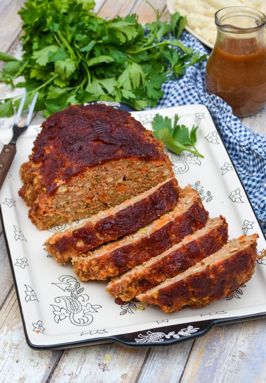 slices of Thanksgiving meatloaf arranged on a serving platter next to a meat fork