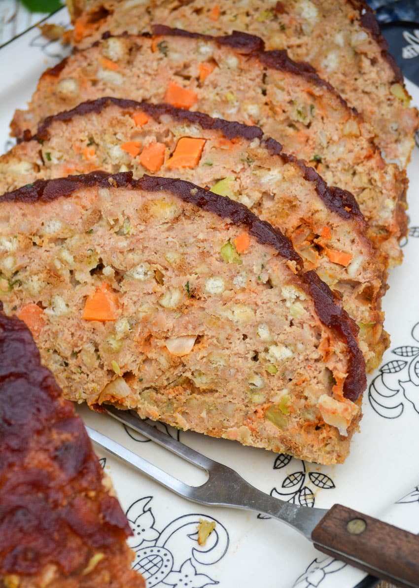 slices of Thanksgiving meatloaf arranged on a serving platter next to a meat fork