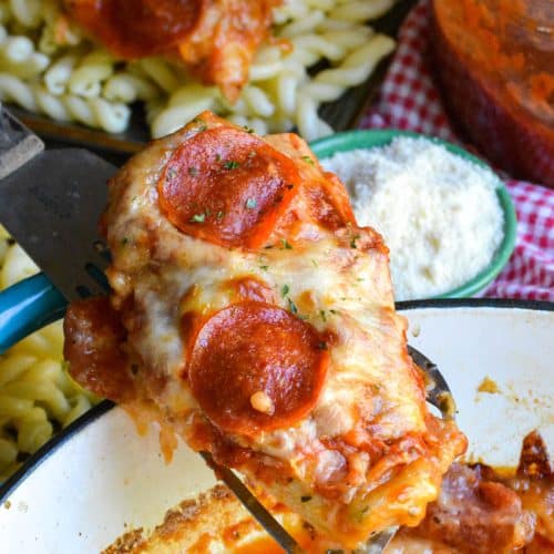 a spatula holding up a piece of baked pizza chicken