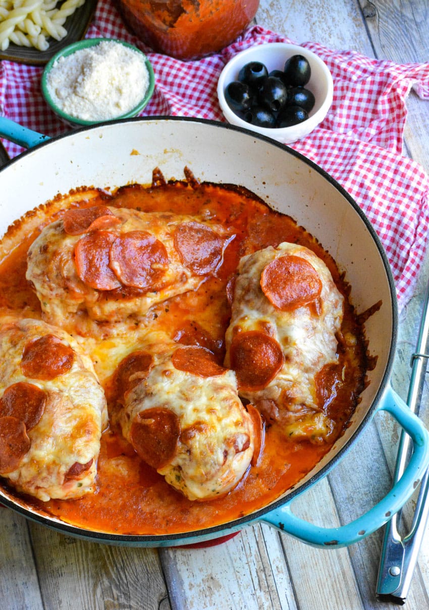 4 pepperoni topped baked pizza chicken breasts in a cast iron skillet