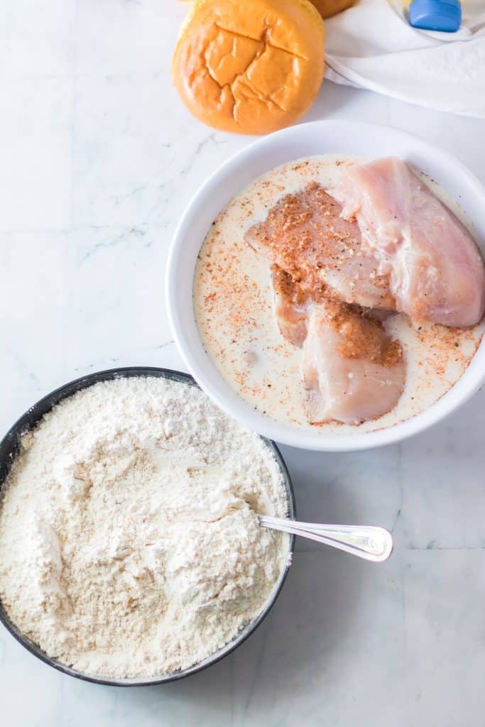 chicken breasts in a bowl of buttermilk