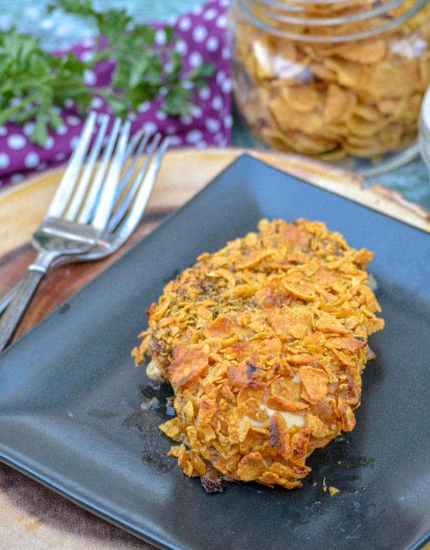 baked cornflake chicken on a black plate