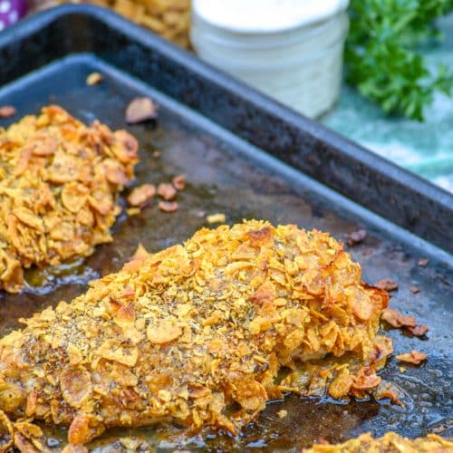 crispy cornflake chicken on a metal baking sheet