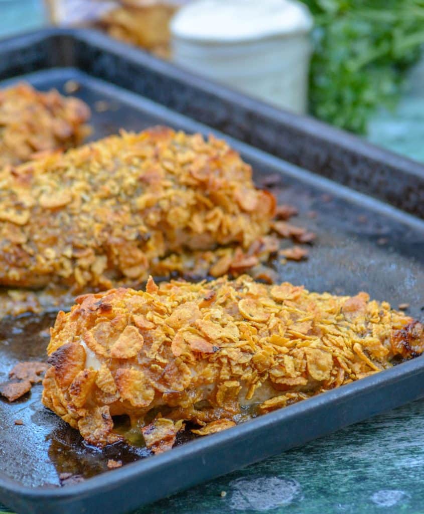 crispy cornflake chicken on a metal baking sheet