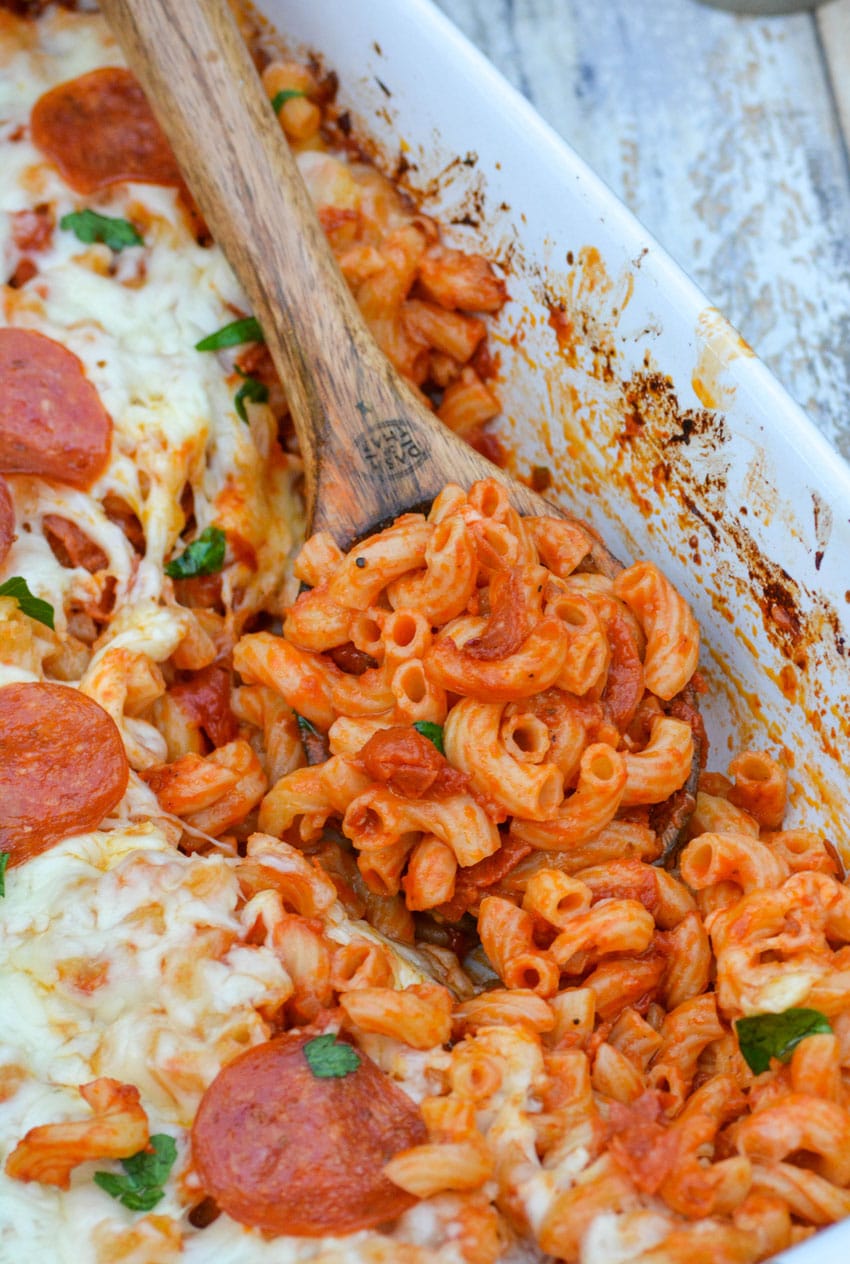 a wooden spoon stuck in a dump and bake pizza casserole